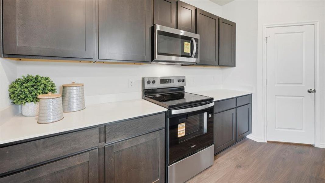 Kitchen featuring appliances with stainless steel finishes and dark wood finished floors