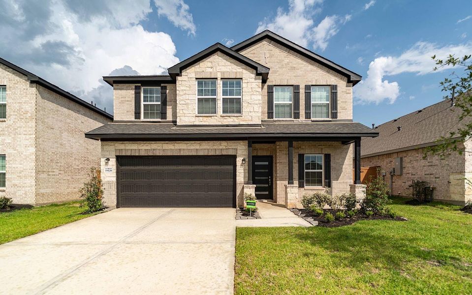 Front exterior of a new home in Cypress Green, Hockley, TX, highlighting curb appeal (Image 1).