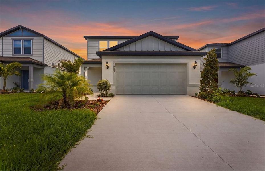 Front exterior of a new home in Oakfield Lakes, Parrish, FL, highlighting curb appeal (Image 2). Front exterior of a new home in Oakfield Lakes, Parrish, FL, highlighting curb appeal (Image 2).