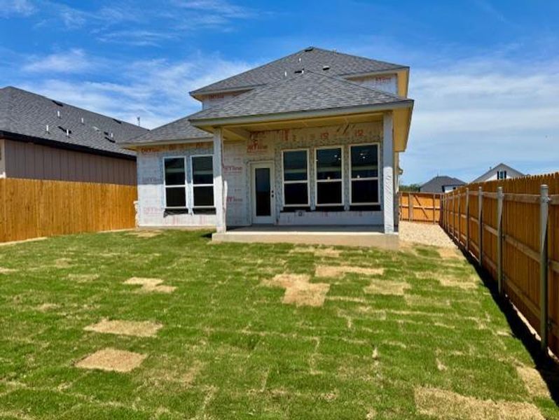 Front exterior of a new home in Heritage, Dripping Springs, TX, highlighting curb appeal (Image 17). Front exterior of a new home in Heritage, Dripping Springs, TX, highlighting curb appeal (Image 17).