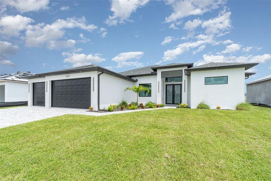 Front exterior of a new home in , Cape Coral, FL, highlighting curb appeal (Image 1).