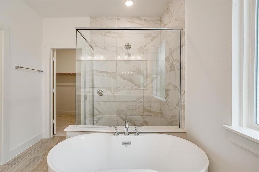 Bathroom featuring tile floors and plus walk in shower