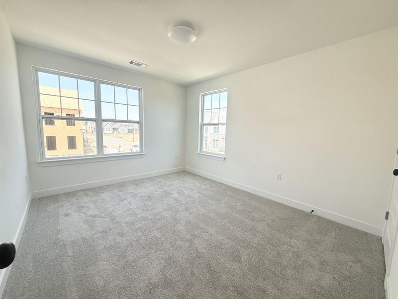 Empty room featuring carpet flooring and baseboards