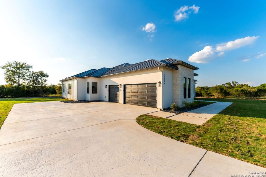 Front exterior of a new home in , Bandera, TX, highlighting curb appeal (Image 1).
