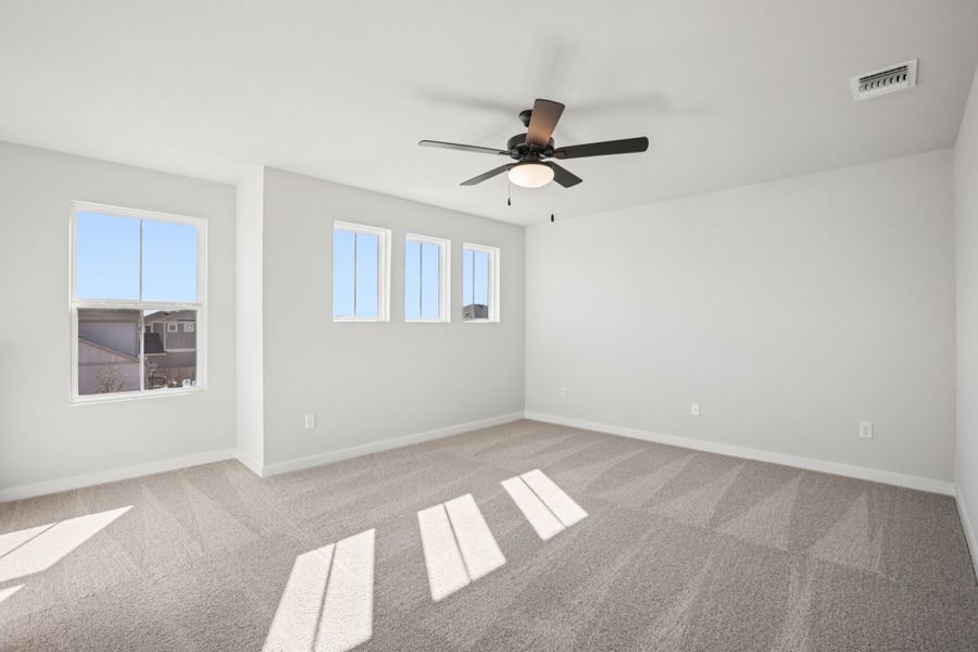 A room with a ceiling fan and a window.