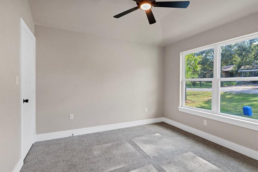 Carpeted spare room with baseboards and a ceiling fan Carpeted spare room with baseboards and a ceiling fan