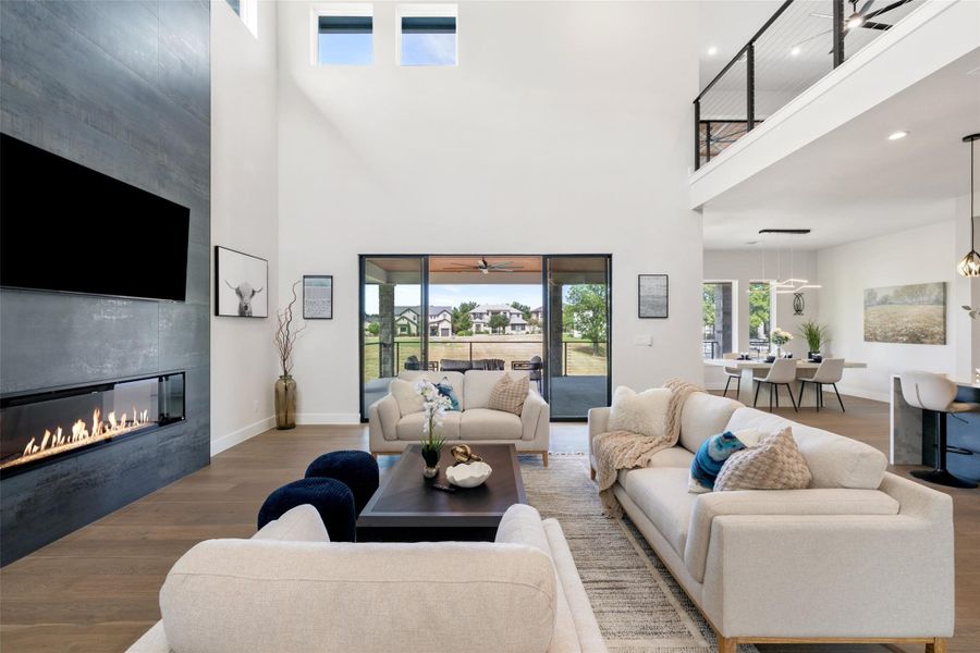 The living room will feature soaringsecond level ceilings and slidingglass doors that show offamazing views of the lake.