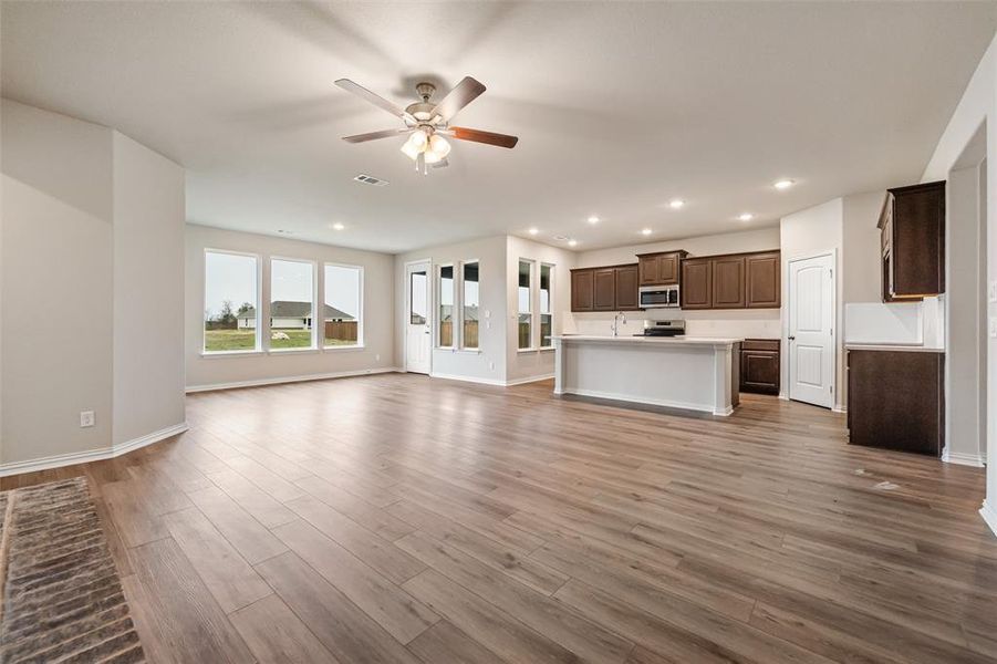 Unfurnished living room with recessed lighting, light wood-style flooring, and a ceiling fan
