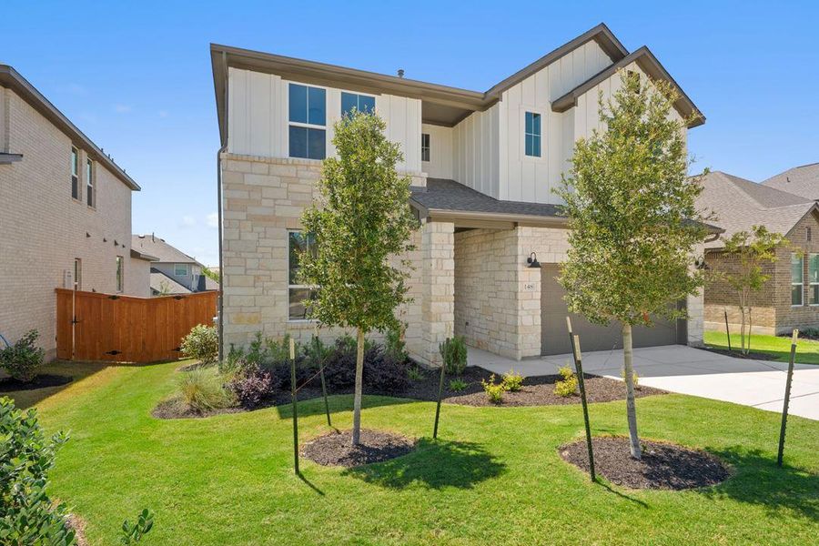 Front exterior of a new home in Lariat, Liberty Hill, TX, highlighting curb appeal (Image 21).