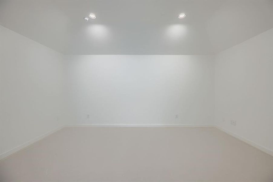 Carpeted empty room featuring recessed lighting and baseboards