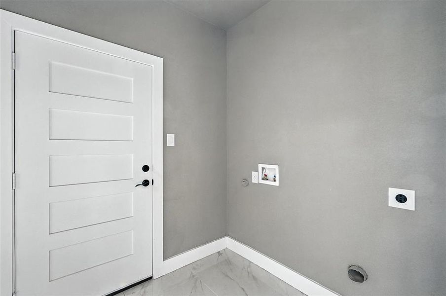 Laundry room featuring hookup for an electric dryer, washer hookup, light marble finish floors, and gas dryer hookup Laundry room featuring hookup for an electric dryer, washer hookup, light marble finish floors, and gas dryer hookup
