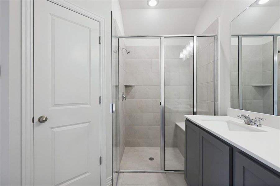 Bathroom featuring vanity and a stall shower