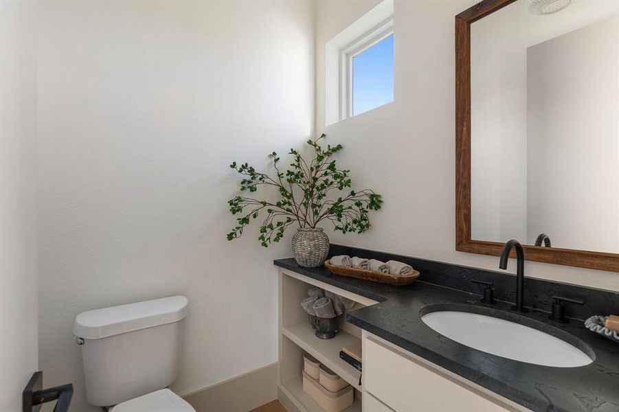 Bathroom featuring toilet and large vanity