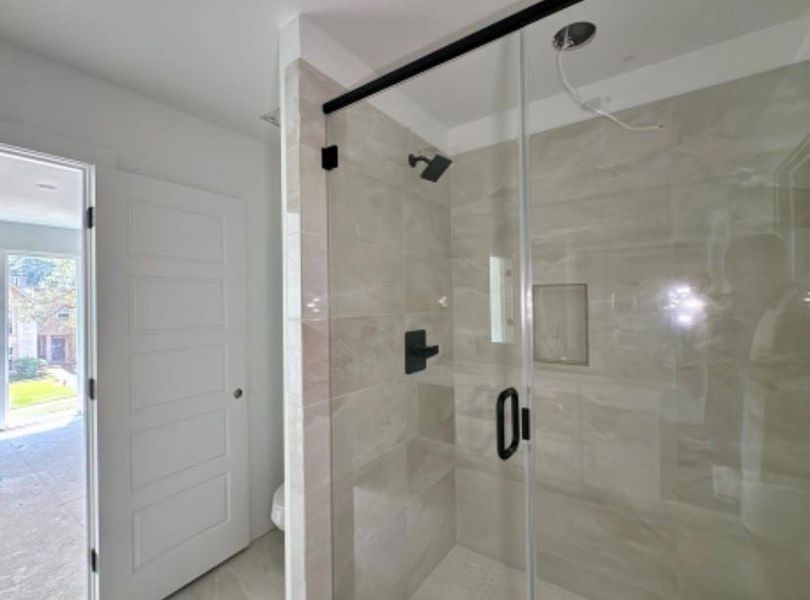 Full bathroom featuring a stall shower and toilet Full bathroom featuring a stall shower and toilet