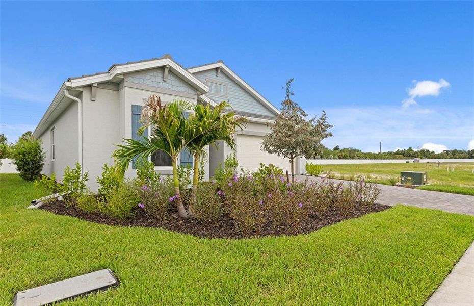 Front exterior of a new home in Shores at Stillwater, Englewood, FL, highlighting curb appeal (Image 24).