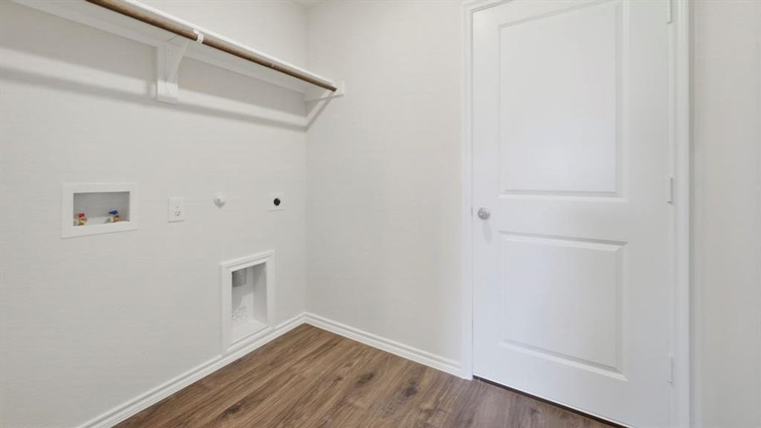 Laundry area featuring gas dryer hookup, dark wood-type flooring, hookup for a washing machine, and hookup for an electric dryer