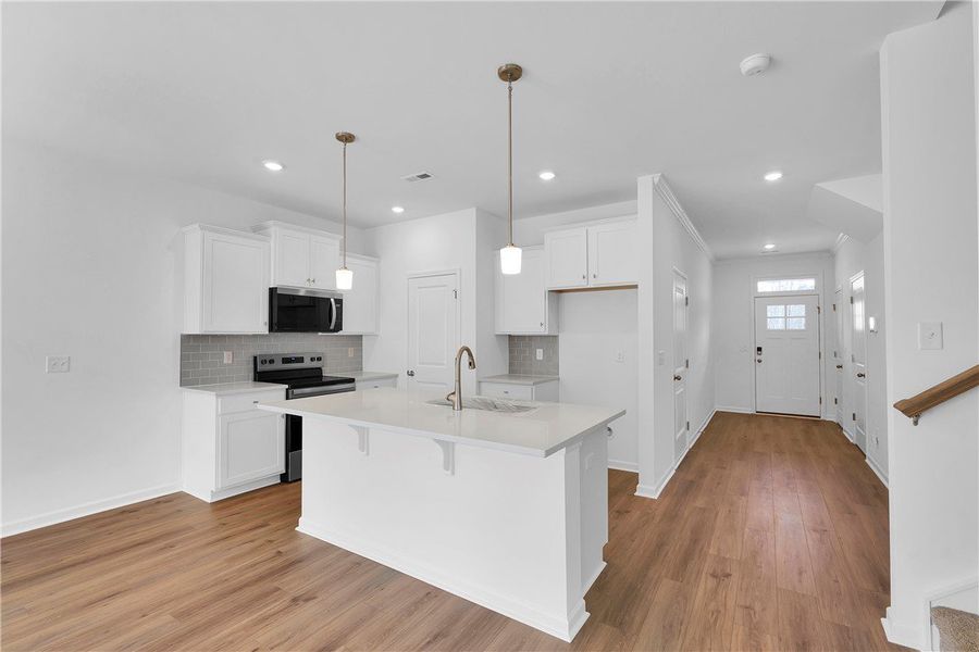 This bright kitchen features an island, ample cabi