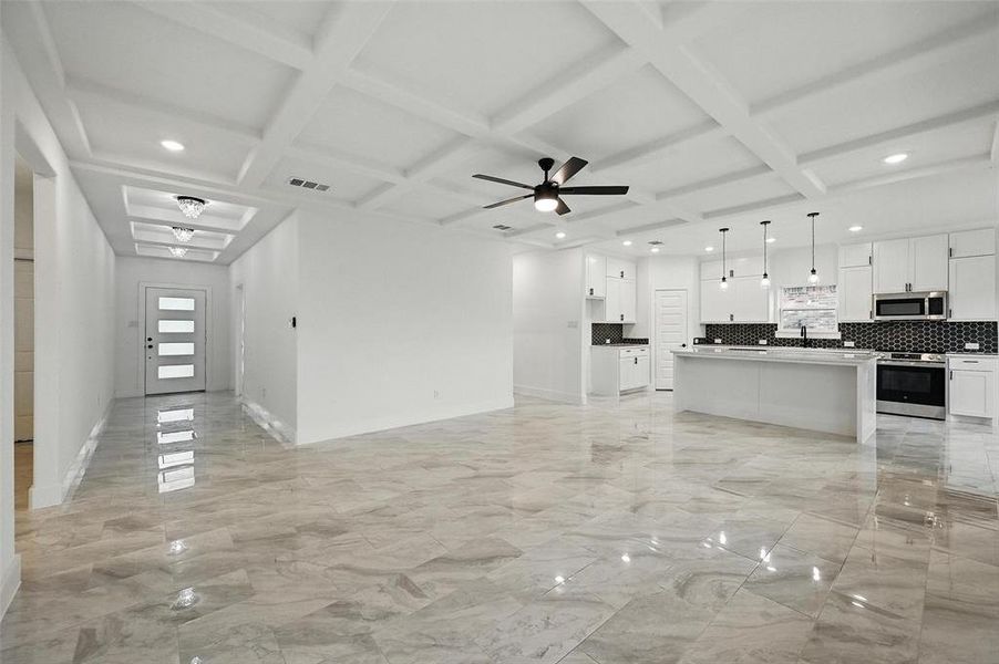 Kitchen featuring appliances with stainless steel finishes, coffered ceiling, open floor plan, tasteful backsplash, and recessed lighting