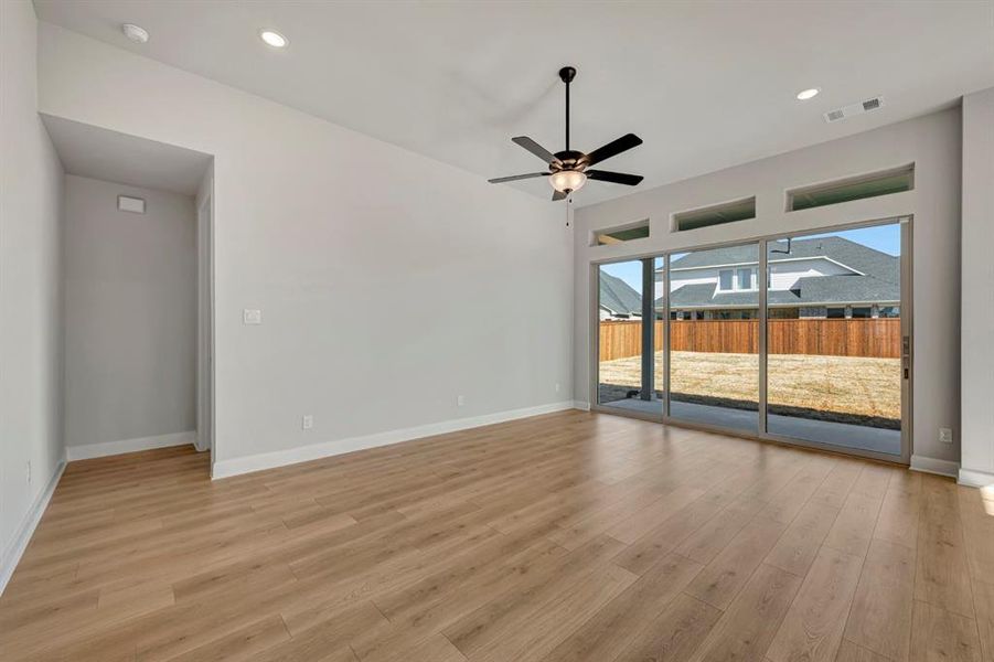 Unfurnished room with a ceiling fan, light wood-type flooring, and recessed lighting