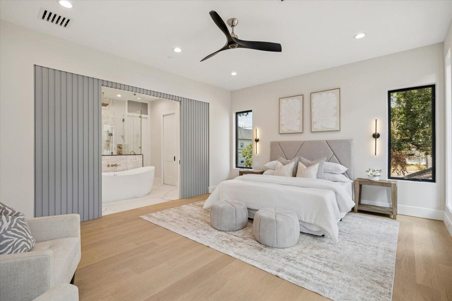 Ascending to the second floor, the primary suite awaits, a sanctuary of indulgence. Outfitted with wood flooring and recessed lighting the room is large enough for a sitting area. Ascending to the second floor, the primary suite awaits, a sanctuary of indulgence. Outfitted with wood flooring and recessed lighting the room is large enough for a sitting area.