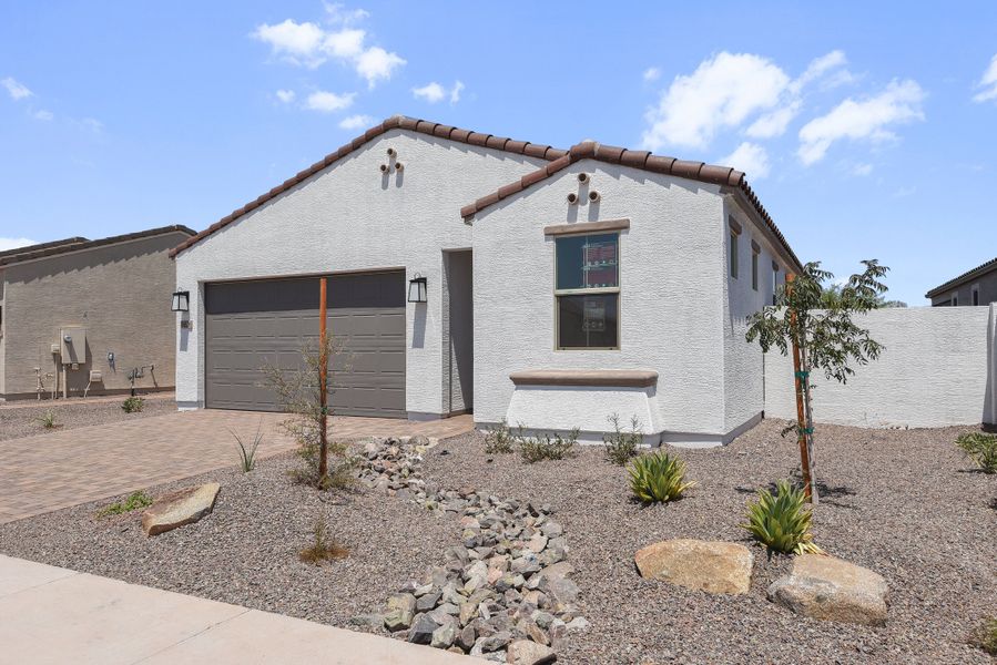 Front exterior of a new home in CantaMia at Estrella 55+, Goodyear, AZ, highlighting curb appeal (Image 25).