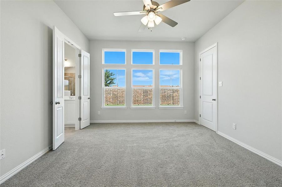Unfurnished bedroom with carpet floors and a ceiling fan Unfurnished bedroom with carpet floors and a ceiling fan