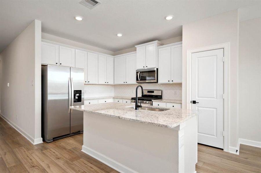 The kitchen has a breakfast bar that will be perfect for serving up some eggs and bacon on a cozy Sunday morning with the family.