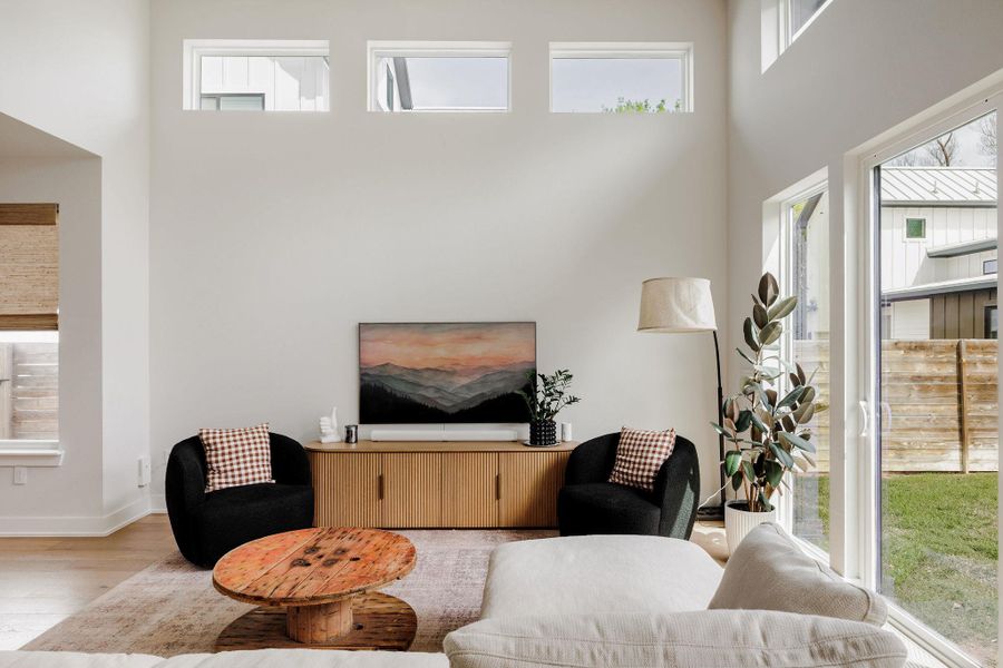 Living room featuring wood finished floors and a high ceiling