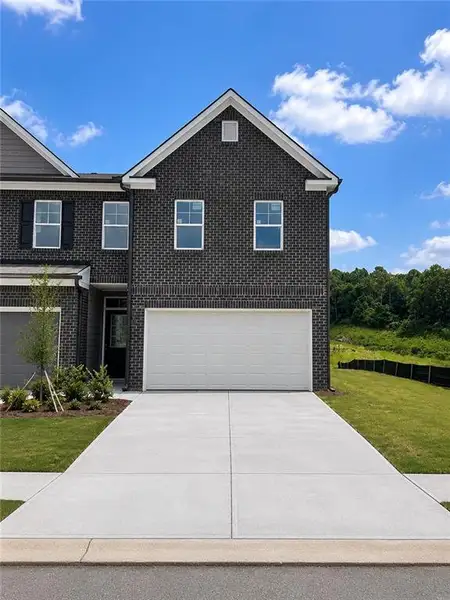 Front exterior of a new home in Reeves Park, Stockbridge, GA, highlighting curb appeal (Image 1). Front exterior of a new home in Reeves Park, Stockbridge, GA, highlighting curb appeal (Image 1).