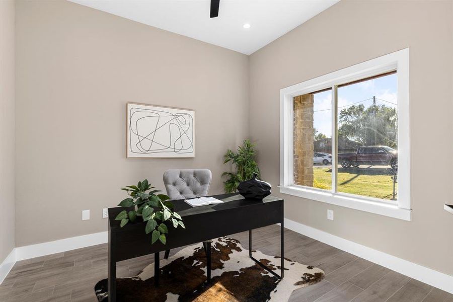 Office area with ceiling fan and hardwood / wood-style flooring