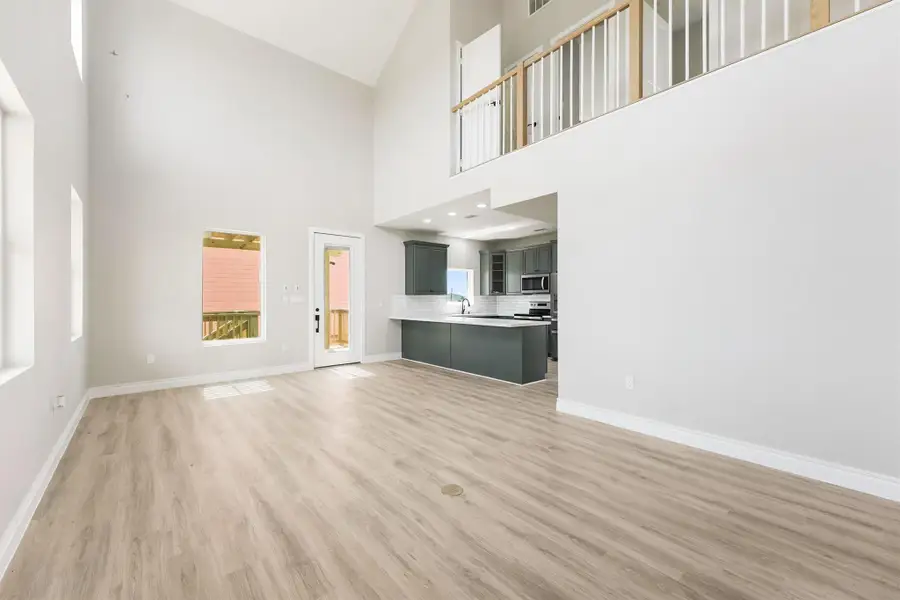 Bright, open-concept living area with high ceilings and natural light. Modern kitchen features stainless steel appliances and an island. Fresh, neutral finishes throughout. Bright, open-concept living area with high ceilings and natural light. Modern kitchen features stainless steel appliances and an island. Fresh, neutral finishes throughout.
