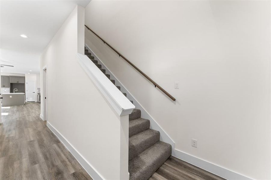 Stairway with carpeted floors and recessed lighting Stairway with carpeted floors and recessed lighting