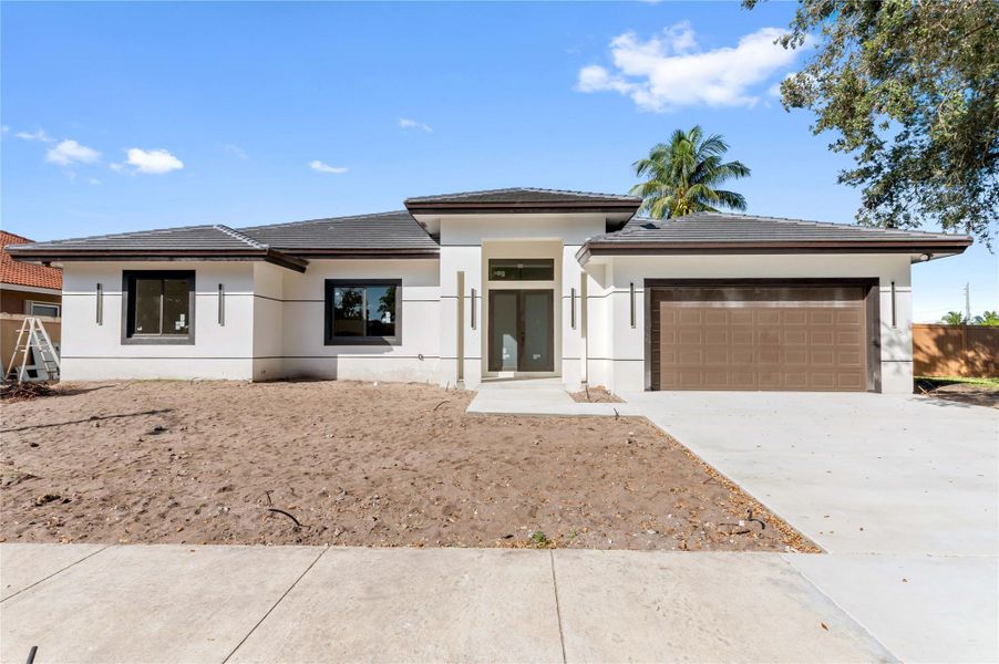 Front exterior of a new home in , Coconut Creek, FL, highlighting curb appeal (Image 1).