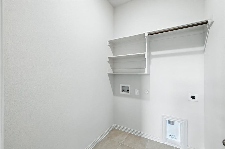 Laundry area with hookup for a washing machine, light tile patterned flooring, electric dryer hookup, and gas dryer hookup Laundry area with hookup for a washing machine, light tile patterned flooring, electric dryer hookup, and gas dryer hookup