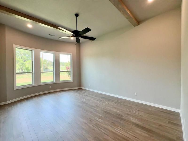 Unfurnished room with beam ceiling, a ceiling fan, wood finished floors, baseboards, and recessed lighting