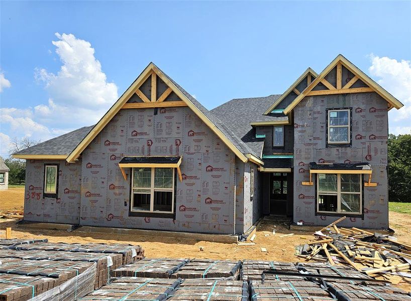 Front exterior of a new home in Pecan Grove, Whitesboro, TX, highlighting curb appeal (Image 2). Front exterior of a new home in Pecan Grove, Whitesboro, TX, highlighting curb appeal (Image 2).