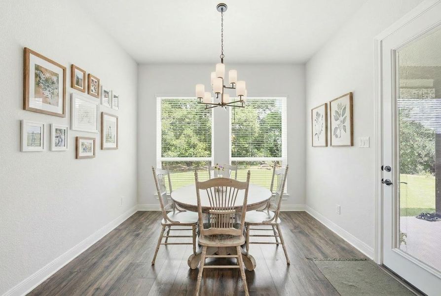 Natural light bathes this charming dining area, featuring stylish wooden flooring and ample room for entertaining. Natural light bathes this charming dining area, featuring stylish wooden flooring and ample room for entertaining.