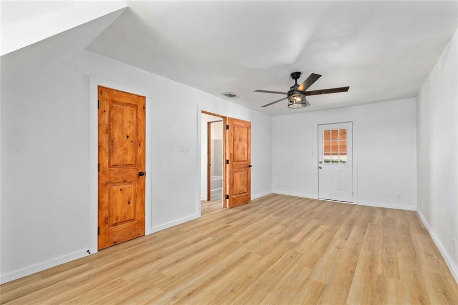 Unfurnished bedroom featuring light wood-style floors and a ceiling fan