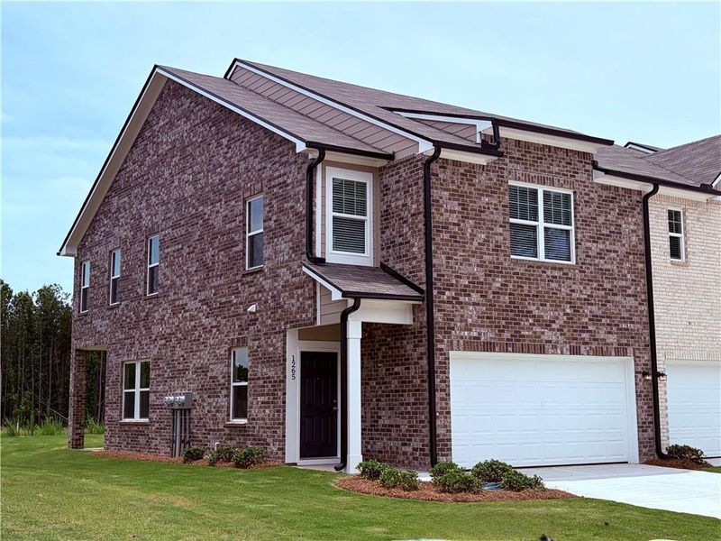 Front exterior of a new home in Kendall Grove, McDonough, GA, highlighting curb appeal (Image 1). Front exterior of a new home in Kendall Grove, McDonough, GA, highlighting curb appeal (Image 1).