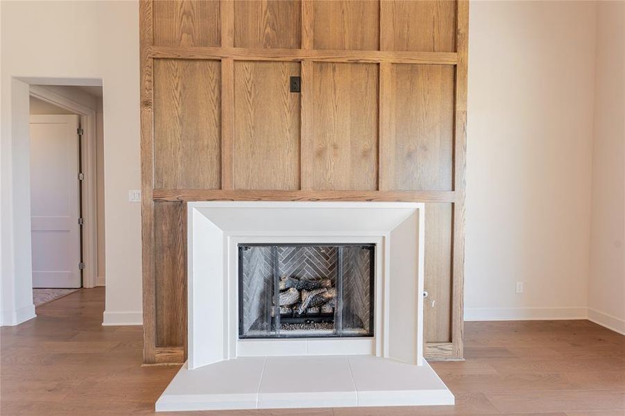 Anchoring the living area is the wood accented floor to ceiling design over the fireplace. Anchoring the living area is the wood accented floor to ceiling design over the fireplace.