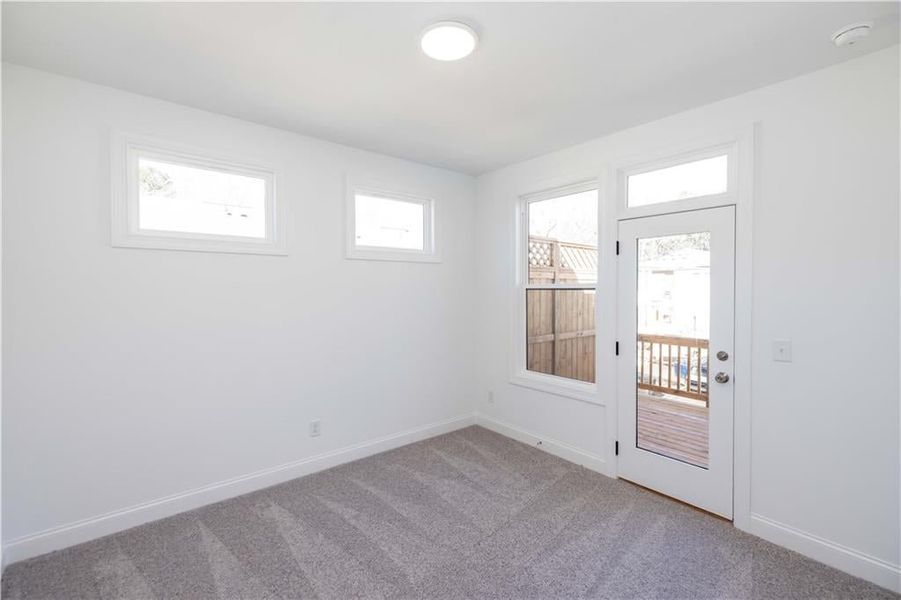 This secondary bedroom has several windows plus a door for access to yet another upper deck.