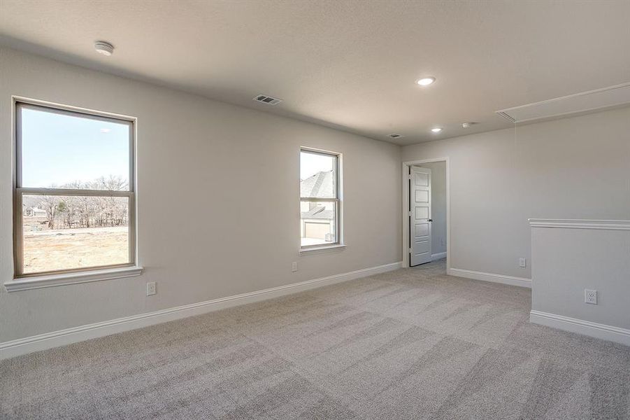 Empty room featuring light carpet and recessed lighting