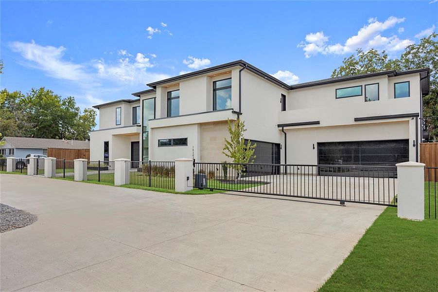 Contemporary house with stucco siding, driveway, and an attached garage