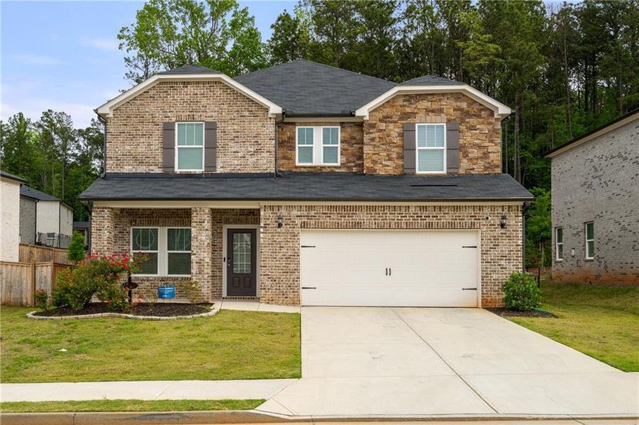 Front exterior of a new home in Creekside at Oxford Park, Fairburn, GA, highlighting curb appeal (Image 1). Front exterior of a new home in Creekside at Oxford Park, Fairburn, GA, highlighting curb appeal (Image 1).