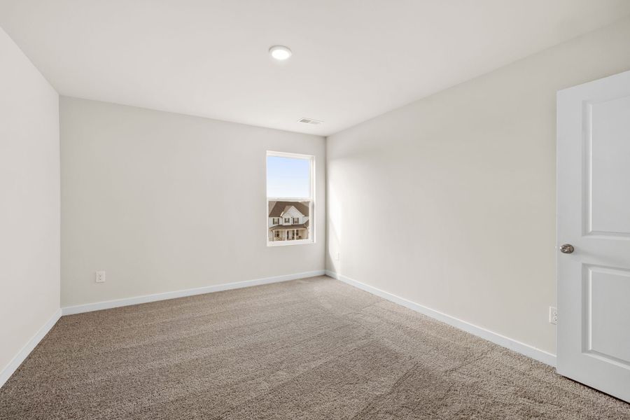 A room with a carpet and a door. A room with a carpet and a door.