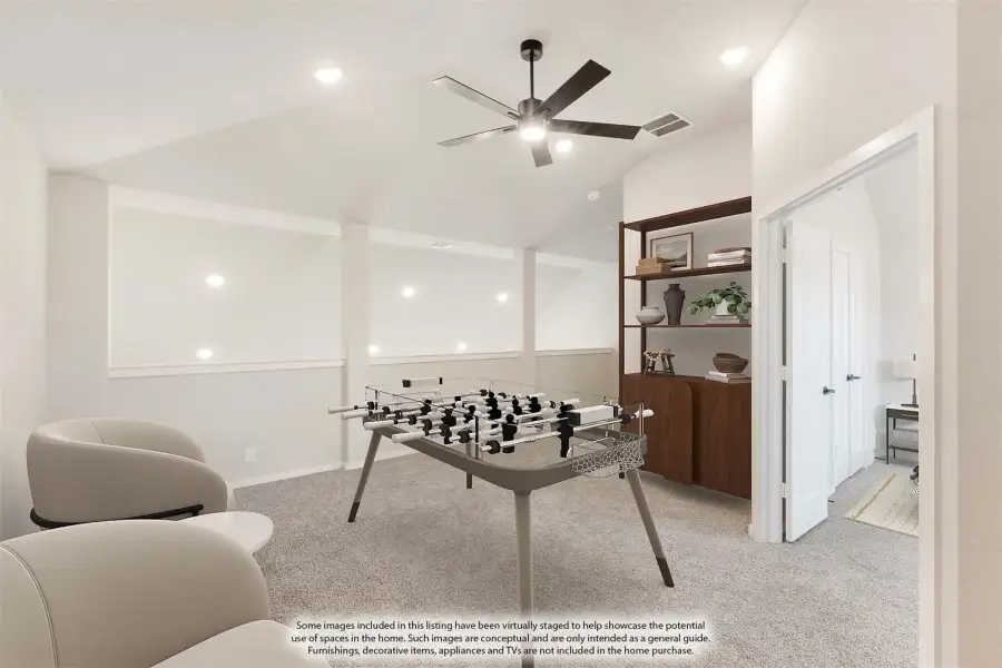Game room with foosball table, ceiling fan, carpet flooring, and wood shelving unit