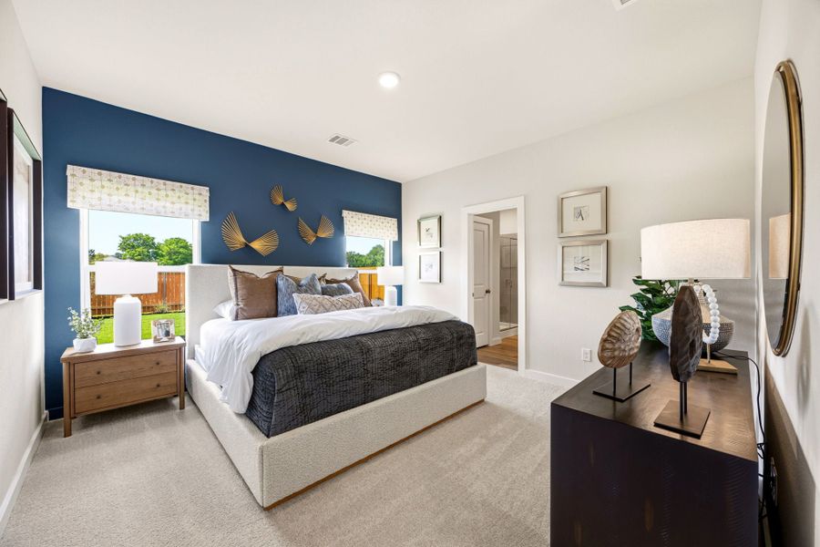 A bedroom with a bed and a desk.