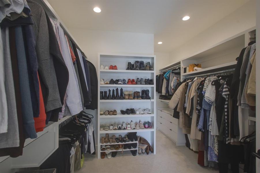 Walk in closet with light carpet