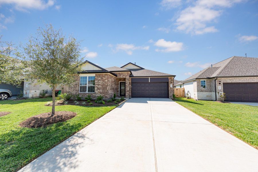Front exterior of a new home in Bluestem, Brookshire, TX, highlighting curb appeal (Image 2).