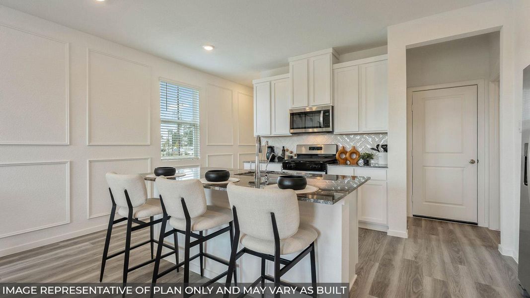 A well-appointed kitchen features a large island with seating, seamlessly blending style and functionality. A well-appointed kitchen features a large island with seating, seamlessly blending style and functionality.